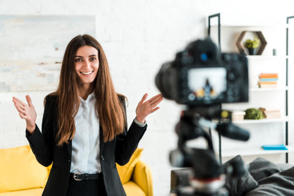 A happy woman is recording a marketing video